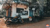 Royal Enfield parked next to a roadside deli in India