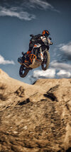 A view of the KTM 2022 1290 Super Adventure S being jumped through the air